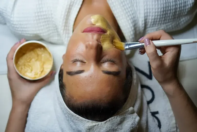 A person applying a natural homemade face mask to reduce hyperpigmentation and brighten the skin