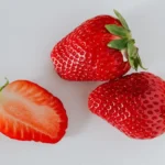 Three fresh strawberries, with potential skincare benefits due to their natural properties
