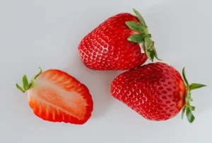 Three fresh strawberries, with potential skincare benefits due to their natural properties
